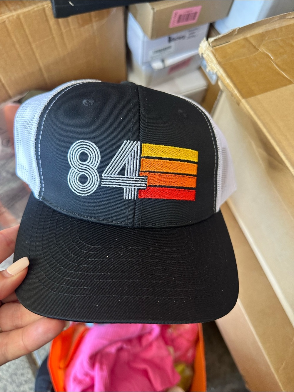 84 Embroidered Black Trucker Hat with Sunset Stripe